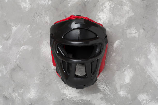 istock Black leather boxing helmet on concrete background, top view. 2159573733