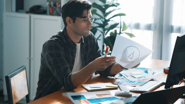 istock Professional designer looking and designing logo graphic at meeting. Symposium. 2159577578
