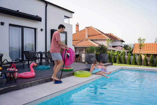 istock A young father prepares inflatables for his children by the pool 2159578973