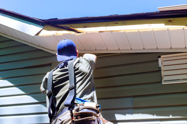 istock As construction process, an employee installs vinyl plastic siding panels on wall facade of a new home 2159580143
