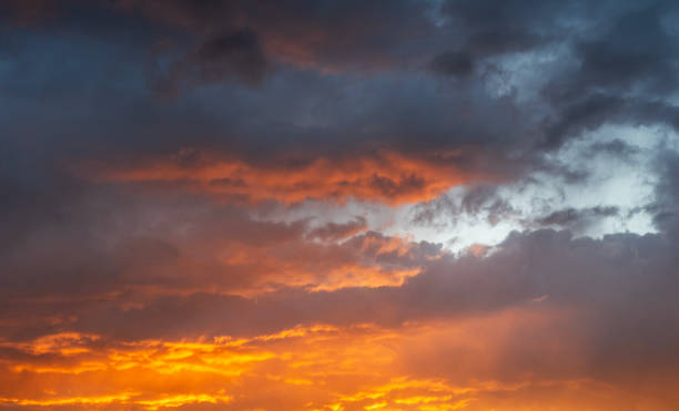 istock Sky background. Bright orange sunset sky with clouds. 2159580468