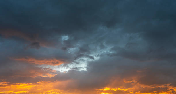 istock Sky background. Bright orange sunset sky with clouds. 2159580469