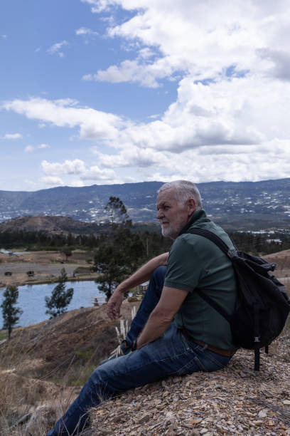 istock Old man sitting resting and looking at the horizon 2159581695