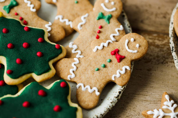 Decorated gingerbread cookies on Christmas festive table