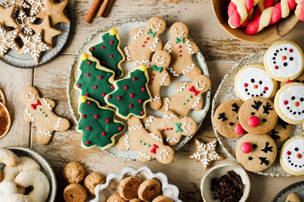 Assorted Christmas cookies on festive table Top view of assorted Christmas cookies on festive table. High angle view of variety fo gingerbread cookies presented on festive table for Christmas celebration. christmas cookies stock pictures, royalty-free photos & images