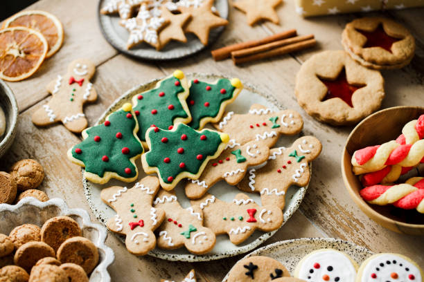istock Decorated gingerbread cookies with spices on table 2159582102