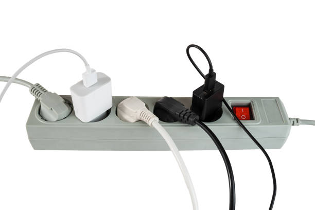 istock Various electrical plugs from electrical appliances connected to an extension cord isolated on a white background 2159582250