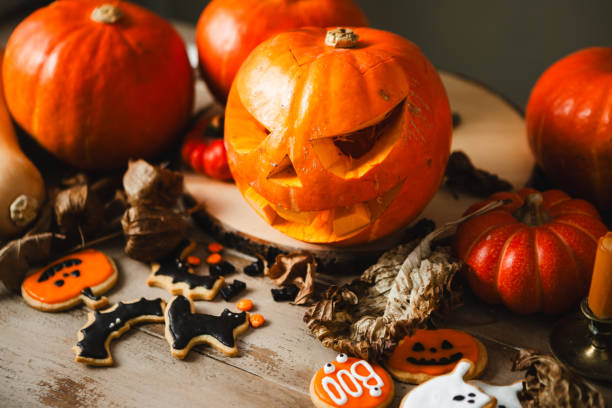 istock Spooky Halloween Celebration Table with Jack-o'-Lantern, Pumpkins and assorted gingerbread cookies 2159582853