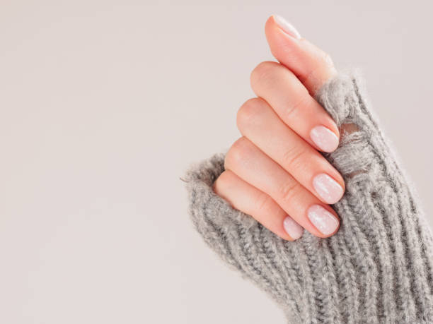 istock Women's manicure shellac soft pink color close-up 2159583500