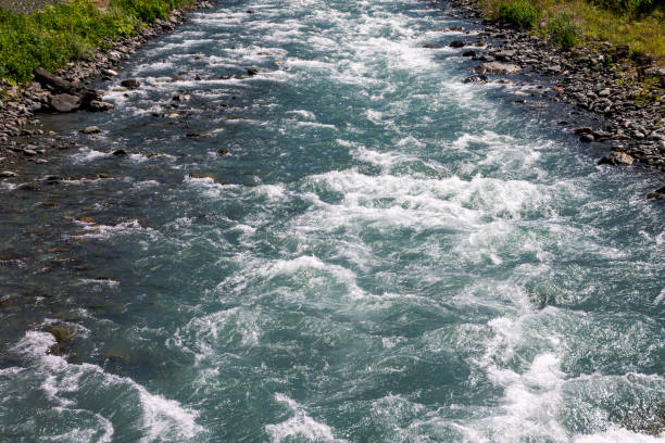 Streams of water from a mountain river, pouring, bubbling and waves of water