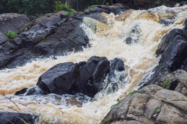 istock a bubbling fast cold river with cliffs and waterfalls, a mountain river with rapids 2159586817