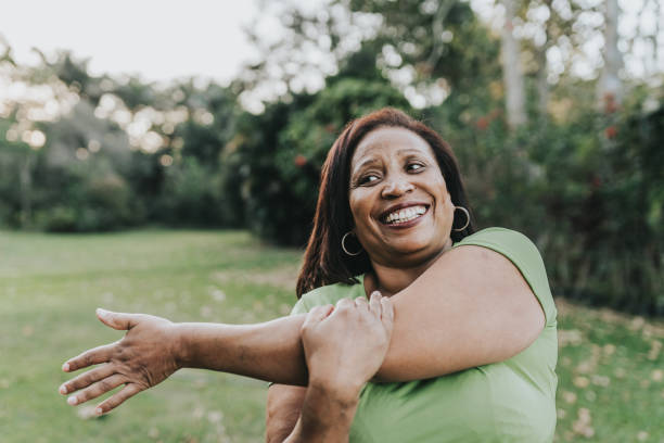 istock Mature woman stretching in public park 2159586837