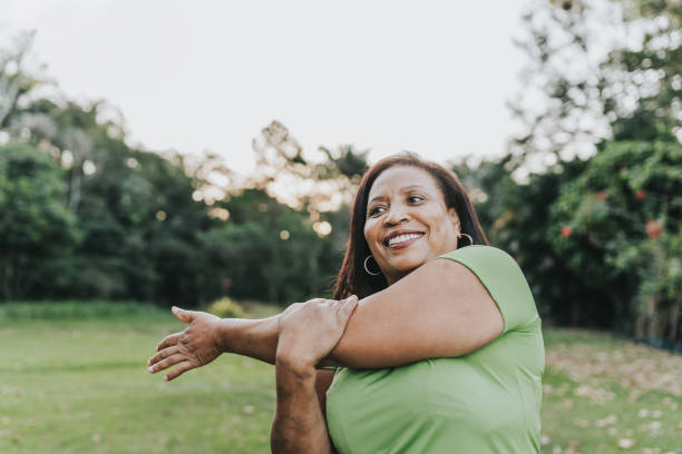 istock Mature woman stretching in public park 2159586838