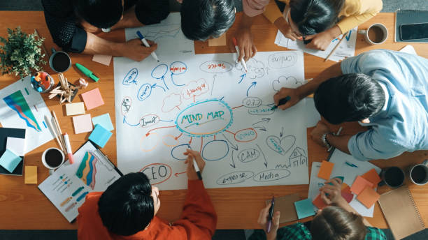 istock Group of business people writing and making mind map at meeting. Convocation. 2159587068