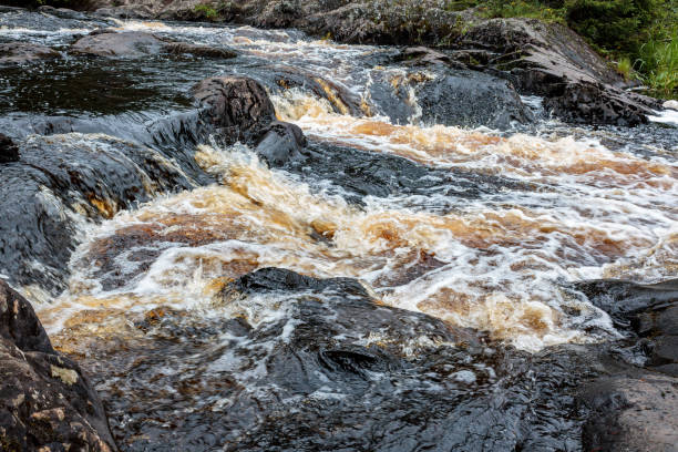 istock a bubbling fast cold river with cliffs and waterfalls, a mountain river with rapids 2159587300