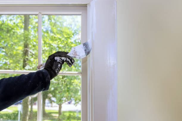 istock Window moldings are painted with white paint with a brush 2159587897