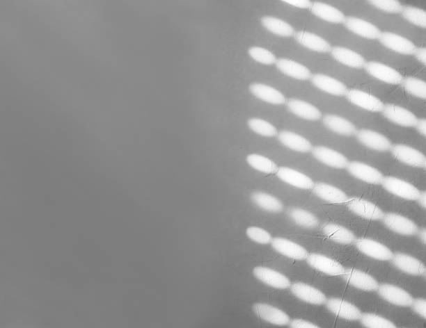 istock Blurred light spots, shadows from the blinds on the concrete wall on a sunny day, Interior design. Abstract background, ads, banner, pattern, texture concept. Gray, white colors. Copy space. 2159588044