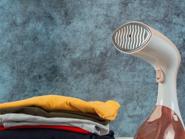 istock Steamer iron for ironing clothes close-up 2159588130