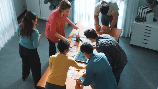 istock Top view of manager writing idea on sticky notes and explain idea. Symposium. 2159589662