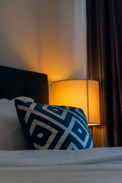 istock Bedroom lit by a warm bedside lamp 2159589883