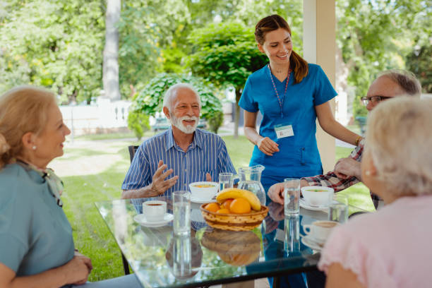 istock Elderly People and Nurse Talking Together in Nursing Home 2159590375