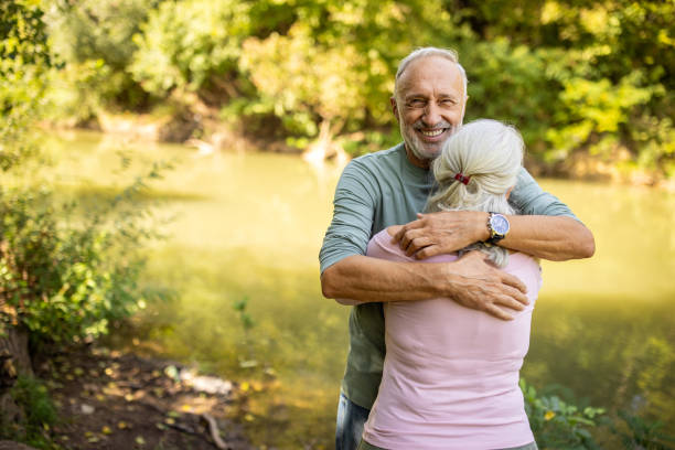 istock Elderly Couple Embracing by the River 2159590691
