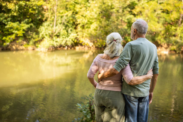 Elderly Couple Embracing by the River