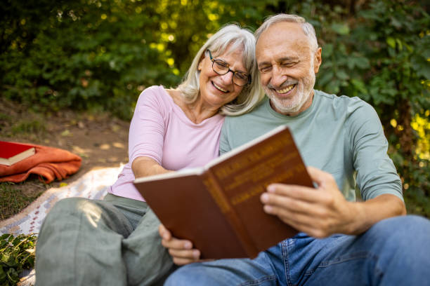 istock Elderly Couple Reading in Nature 2159591024