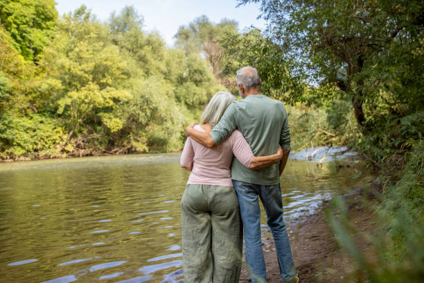 istock Elderly Couple Embracing by the River 2159591459