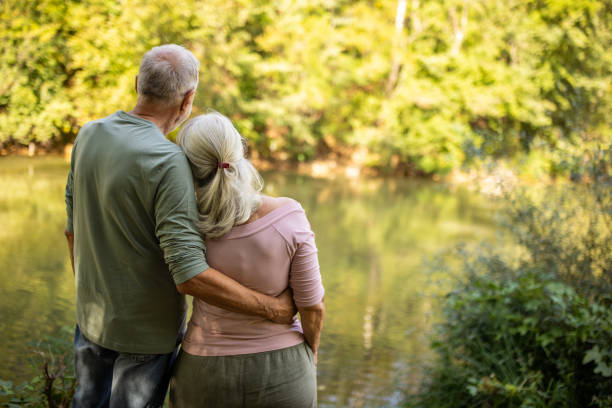 istock Senior Couple Embracing by the River 2159591486