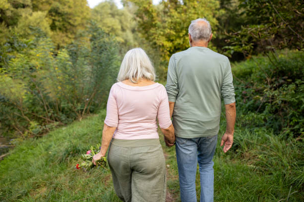 istock Elderly Couple Taking a Walk in Nature 2159591553