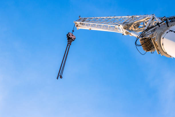 istock Construction crane arm with hook with cable against clear blue sky background. Industrial equipment or tools. Copy space. Selective focus. 2159591640
