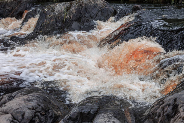 istock a bubbling fast cold river with cliffs and waterfalls, a mountain river with rapids 2159592795