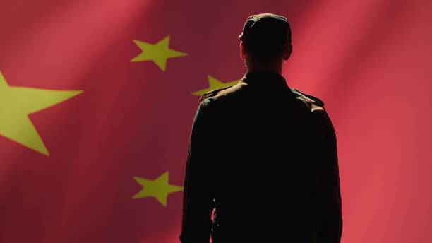 istock Soldier doing salute hand gesture towards Chinese flag 2159592856