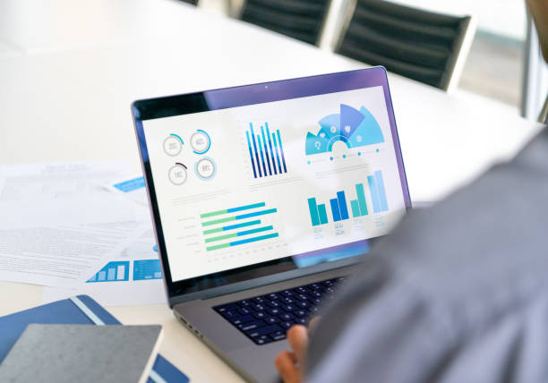 istock Close up of businessman using a laptop with graphs and charts on a laptop computer. 2159593612