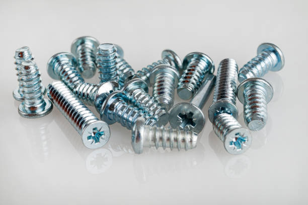 Bolts screws self-tapping screws of various shapes and sizes for connecting fastener elements isolated on a white background close-up