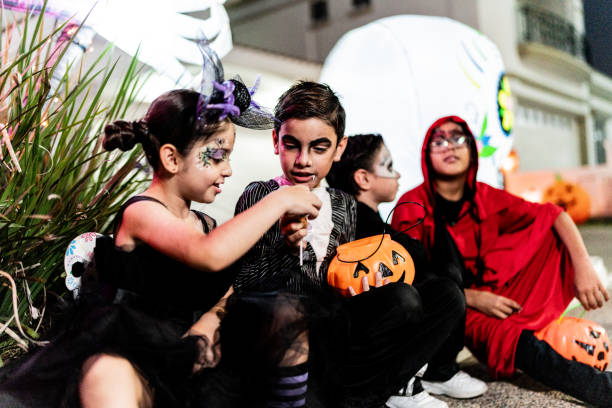 istock Children talking after picking up candy on Halloween 2159594325