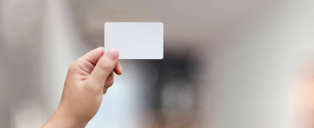 istock man holding a credit/debit card in his hand 2159595590