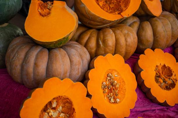 istock Close-up of ripe pumpkins at the bazaar. Background. Texture. 2159596064