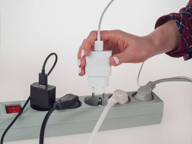istock Various electrical plugs from electrical appliances connected to an extension cord isolated on a white background 2159596167
