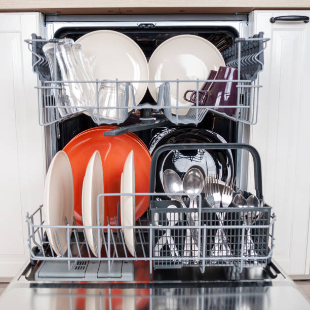 istock Modern dishwasher built into the kitchen unit for washing dishes close 2159596267