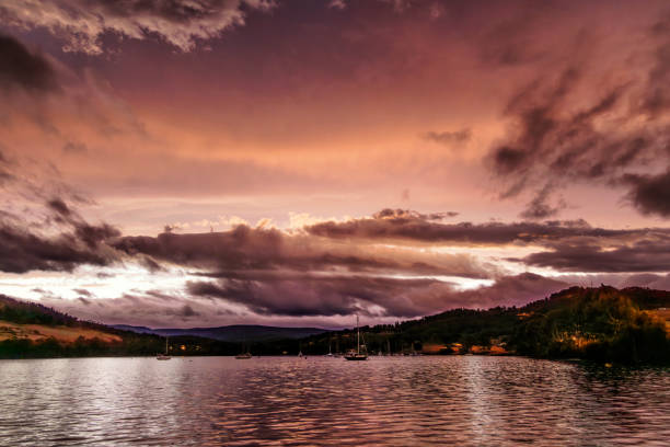 Beautiful hues after sunset lighting up clouds and reflected in water