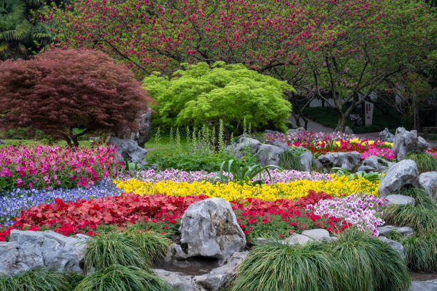 A surreal image depicting a formal garden with outlandish multi colored plants and flowers.