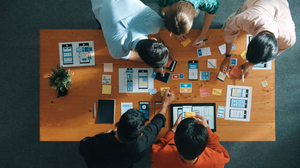 istock Top view of skilled business team writing idea on sticky note. Convocation. 2159600757