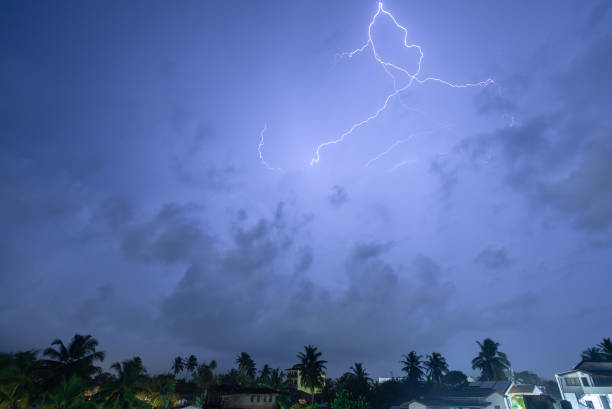 istock A powerful lightning bolt illuminates the night sky above a city, creating a dramatic scene. 2159601122