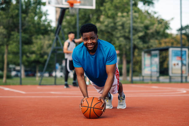 istock Basketball player doing pushups while holding a ball in front of him 2159601224