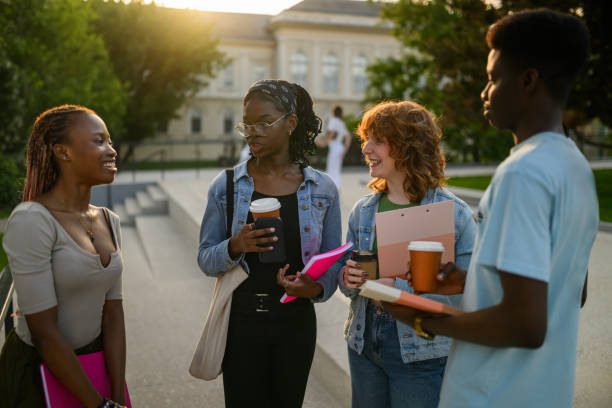 istock Diverse group of students at campus on break near university building. 2159601239