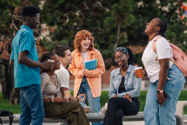 istock Cheerful group of diverse students having fun on coffee break at campus 2159601247