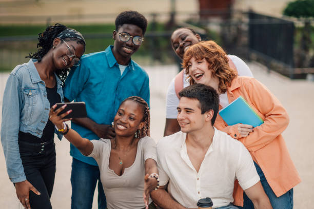 istock Cheerful diverse college friends taking selfies at university campus. 2159601252