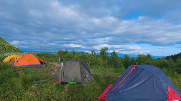 istock Four tents pitched in a scenic outdoor mountain setting 2159601487